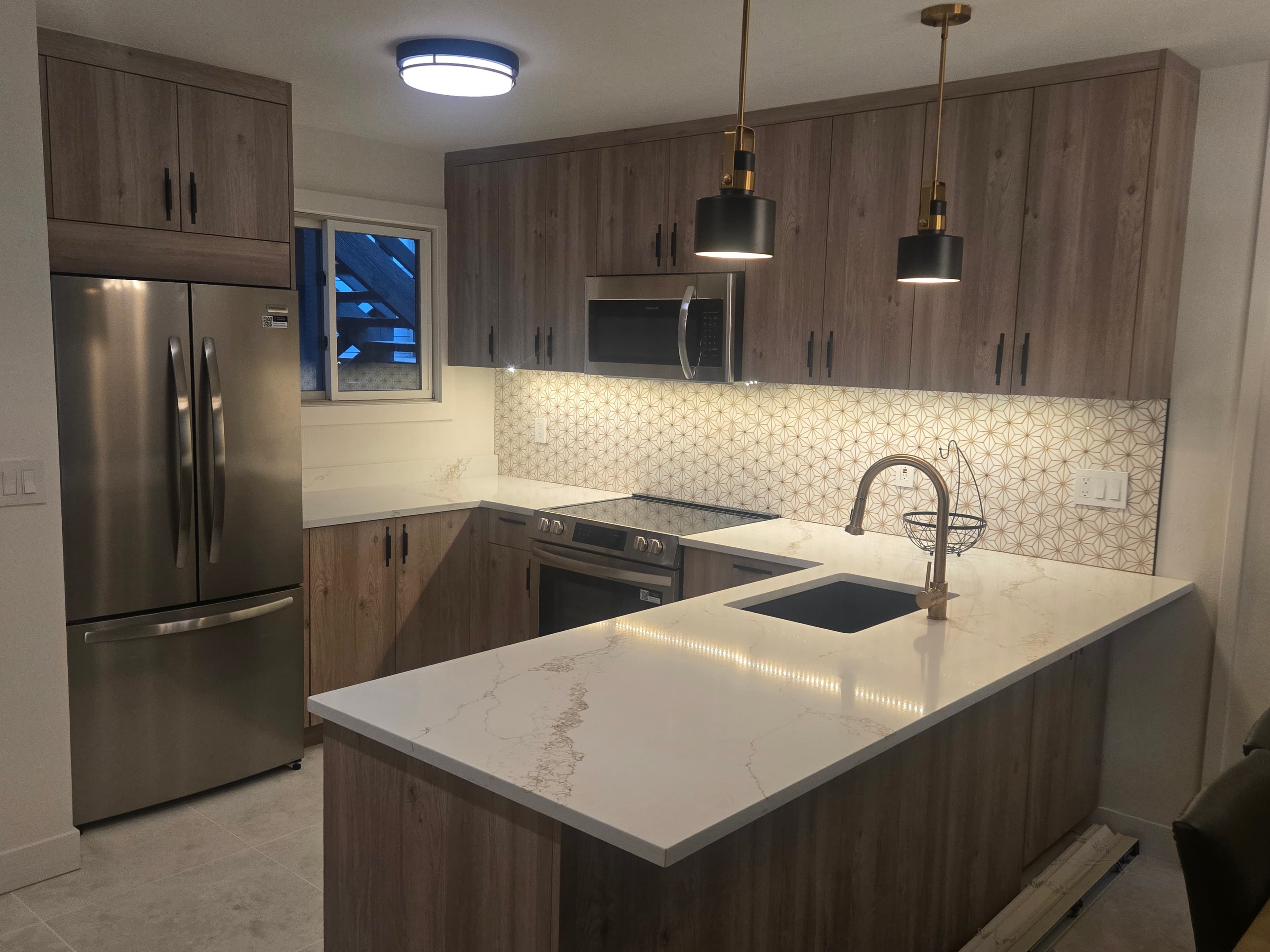 Remodeled Park City ski condo kitchen with quartz peninsula